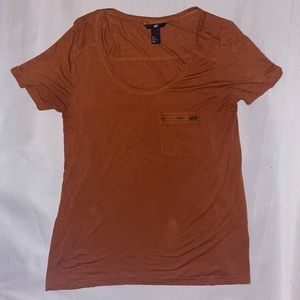 Orange top with zippered pocket detail